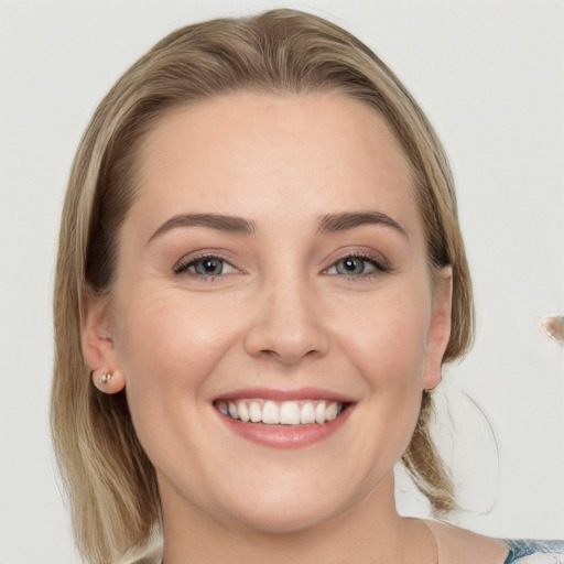 Joyful white young-adult female with medium  brown hair and blue eyes