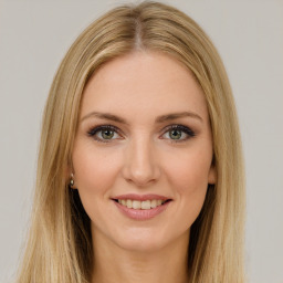 Joyful white young-adult female with long  brown hair and green eyes