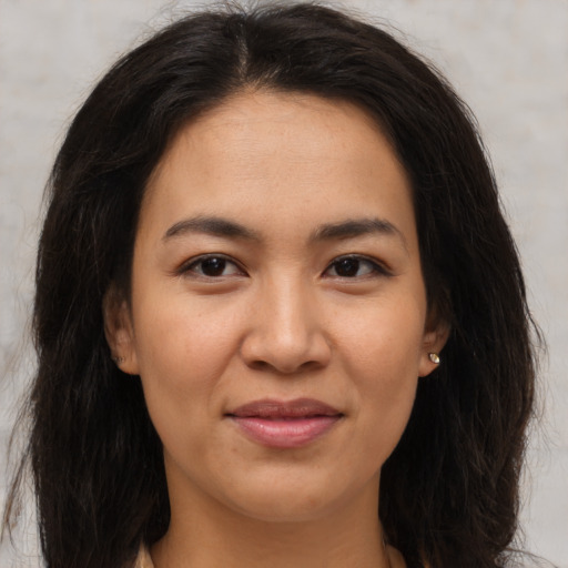 Joyful asian young-adult female with long  brown hair and brown eyes