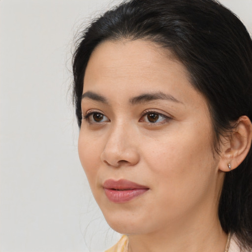 Joyful white young-adult female with medium  black hair and brown eyes