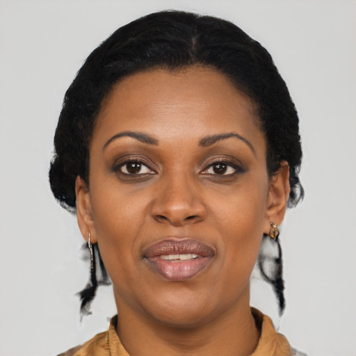 Joyful black adult female with medium  brown hair and brown eyes
