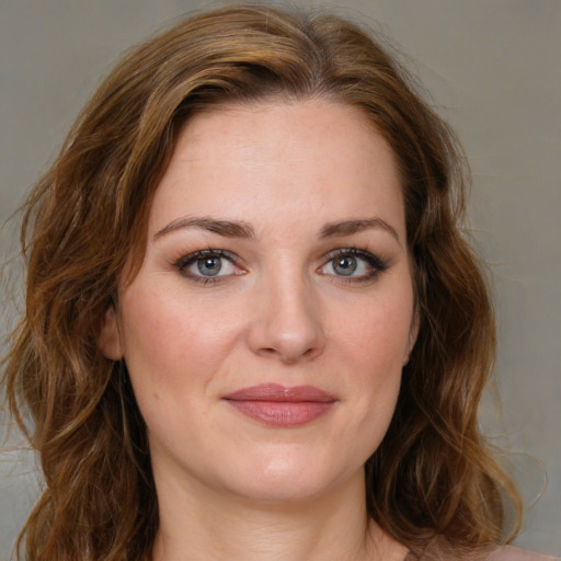 Joyful white young-adult female with medium  brown hair and green eyes