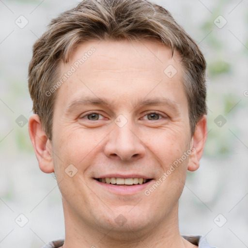 Joyful white adult male with short  brown hair and grey eyes