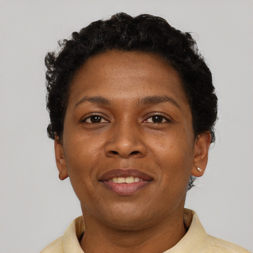 Joyful black adult female with short  brown hair and brown eyes