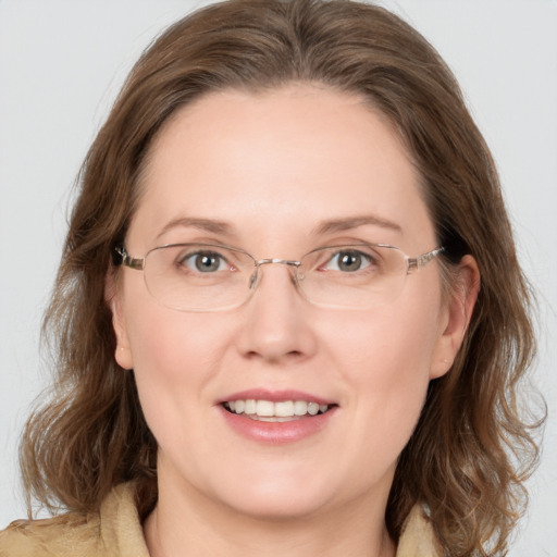 Joyful white adult female with medium  brown hair and grey eyes