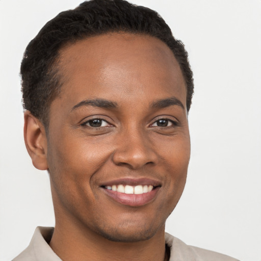 Joyful black young-adult male with short  brown hair and brown eyes