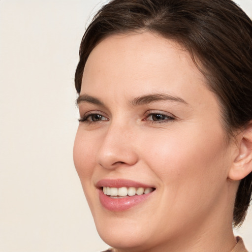 Joyful white young-adult female with medium  brown hair and brown eyes