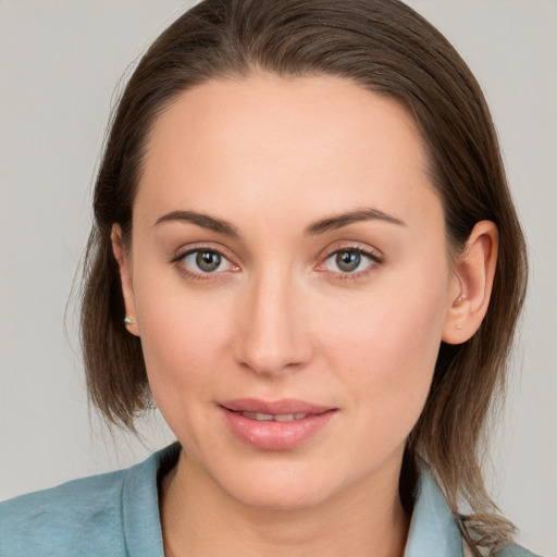 Joyful white young-adult female with medium  brown hair and grey eyes