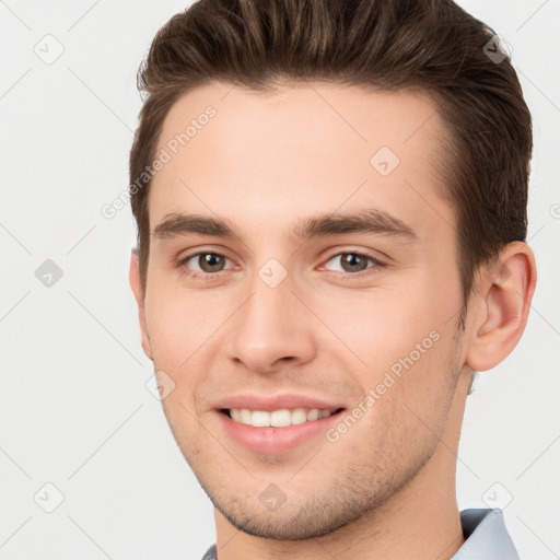 Joyful white young-adult male with short  brown hair and brown eyes