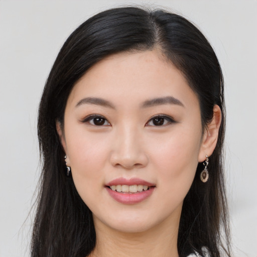 Joyful asian young-adult female with long  brown hair and brown eyes