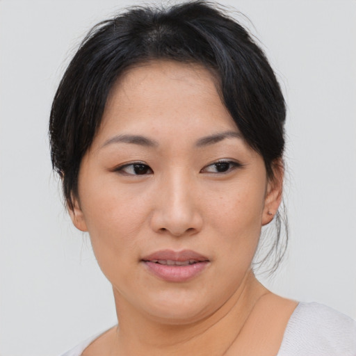 Joyful asian young-adult female with medium  brown hair and brown eyes