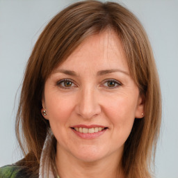 Joyful white adult female with medium  brown hair and brown eyes