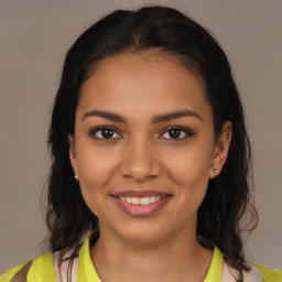 Joyful latino young-adult female with medium  brown hair and brown eyes