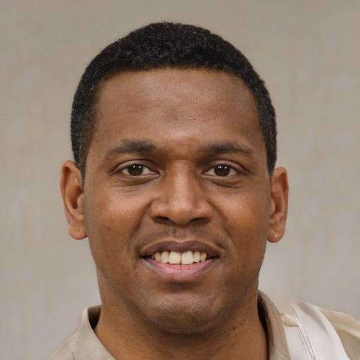 Joyful latino young-adult male with short  brown hair and brown eyes