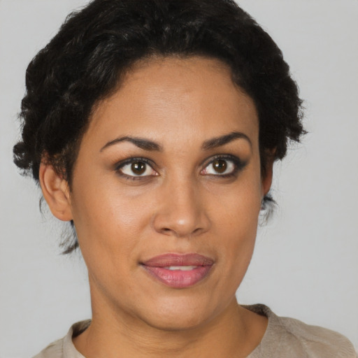 Joyful latino young-adult female with short  brown hair and brown eyes