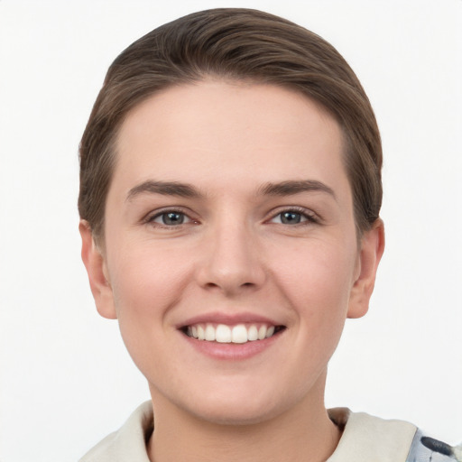 Joyful white young-adult female with short  brown hair and grey eyes