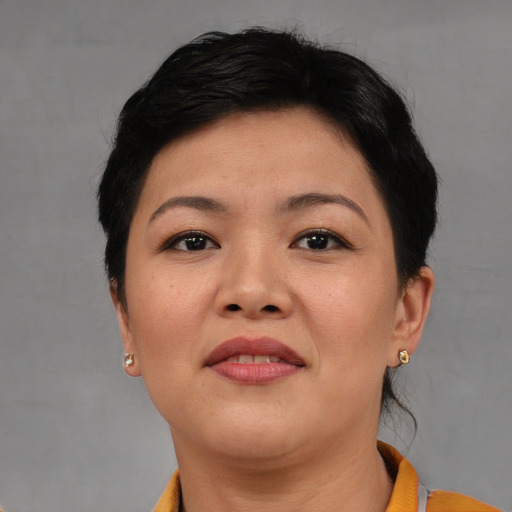 Joyful asian young-adult female with short  brown hair and brown eyes