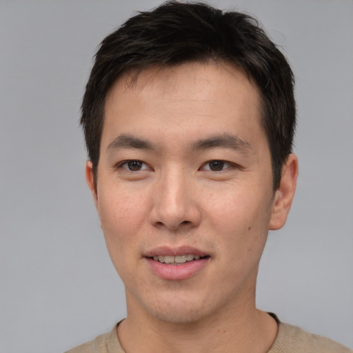 Joyful asian young-adult male with short  brown hair and brown eyes