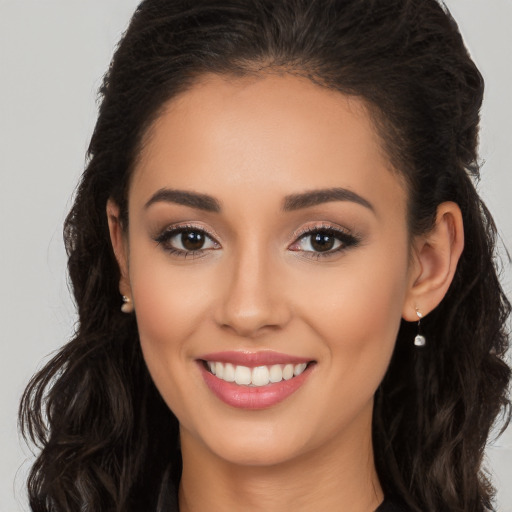 Joyful white young-adult female with long  brown hair and brown eyes