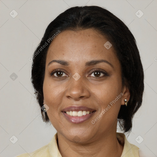 Joyful black adult female with medium  brown hair and brown eyes