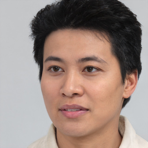 Joyful white young-adult male with short  black hair and brown eyes