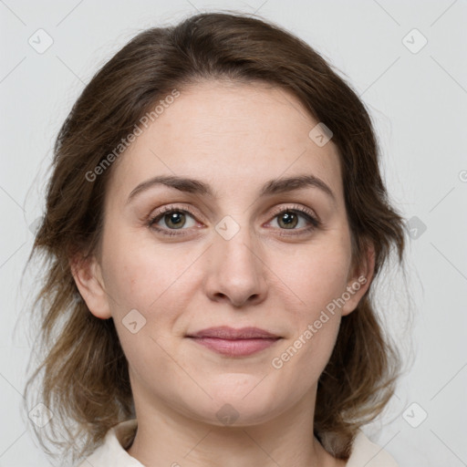 Joyful white young-adult female with medium  brown hair and green eyes