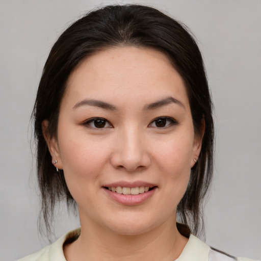 Joyful asian young-adult female with medium  brown hair and brown eyes