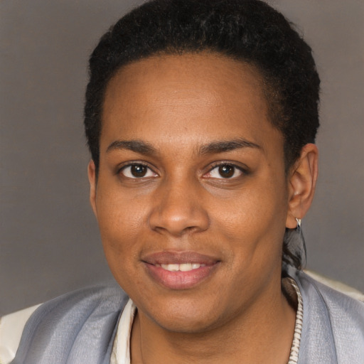 Joyful black young-adult female with short  brown hair and brown eyes