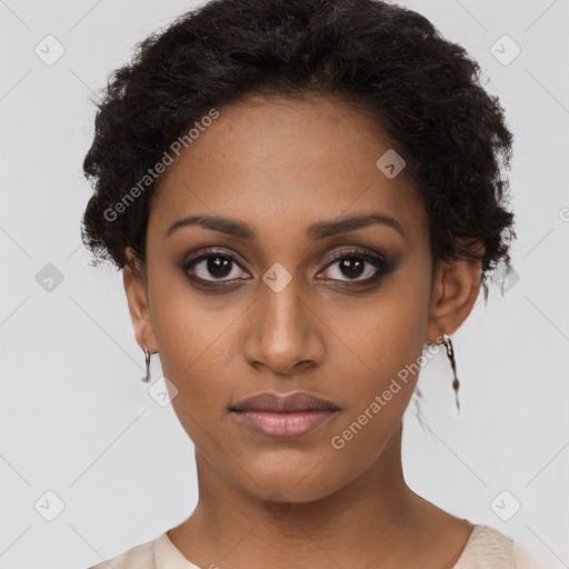 Joyful black young-adult female with short  brown hair and brown eyes