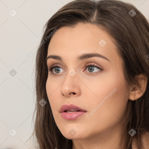 Neutral white young-adult female with long  brown hair and brown eyes