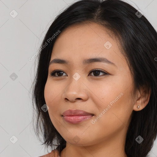 Joyful asian young-adult female with long  brown hair and brown eyes