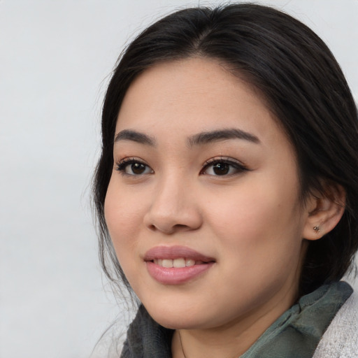 Joyful asian young-adult female with medium  black hair and brown eyes