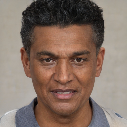 Joyful white adult male with short  black hair and brown eyes