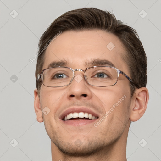 Joyful white young-adult male with short  brown hair and grey eyes