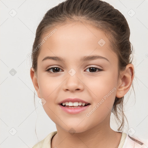 Joyful white child female with medium  brown hair and brown eyes