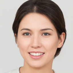 Joyful white young-adult female with medium  brown hair and brown eyes