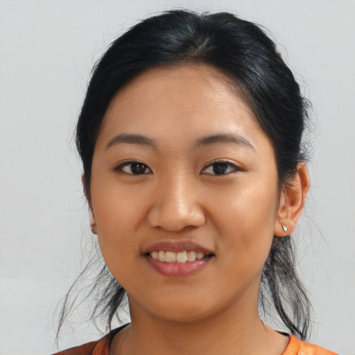 Joyful asian young-adult female with medium  black hair and brown eyes