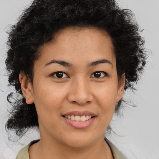 Joyful black young-adult female with medium  brown hair and brown eyes