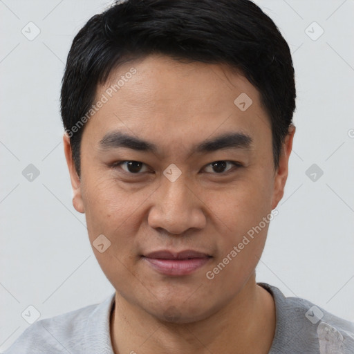 Joyful asian young-adult male with short  black hair and brown eyes