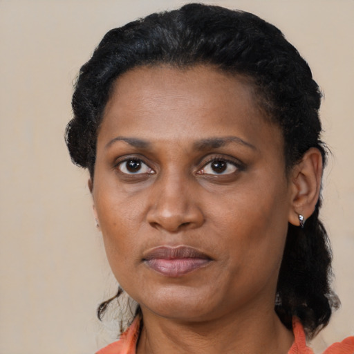 Joyful black adult female with medium  black hair and brown eyes