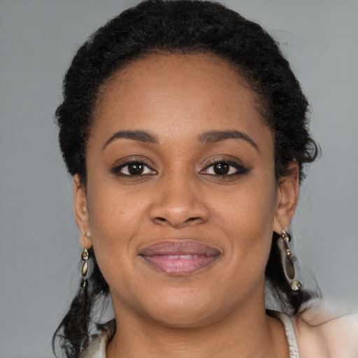Joyful black young-adult female with medium  brown hair and brown eyes