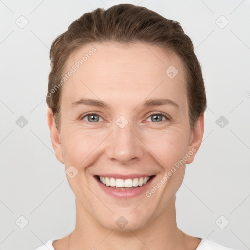 Joyful white young-adult female with short  brown hair and grey eyes