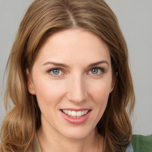 Joyful white young-adult female with medium  brown hair and green eyes