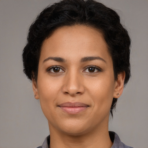 Joyful latino young-adult female with short  brown hair and brown eyes