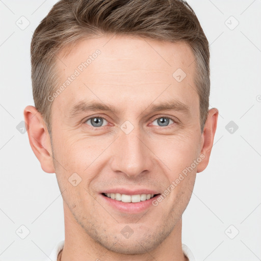 Joyful white young-adult male with short  brown hair and grey eyes