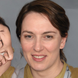 Joyful white adult female with medium  brown hair and brown eyes