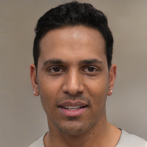 Joyful white young-adult male with short  black hair and brown eyes