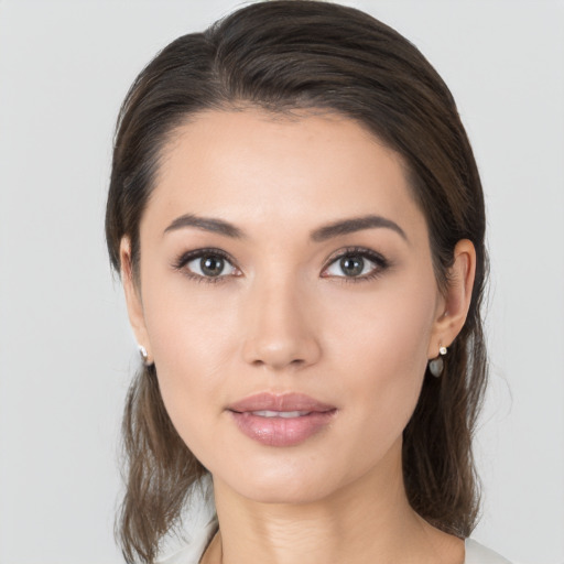 Joyful white young-adult female with medium  brown hair and brown eyes