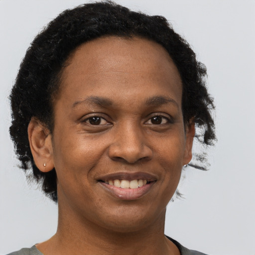 Joyful black young-adult female with short  brown hair and brown eyes