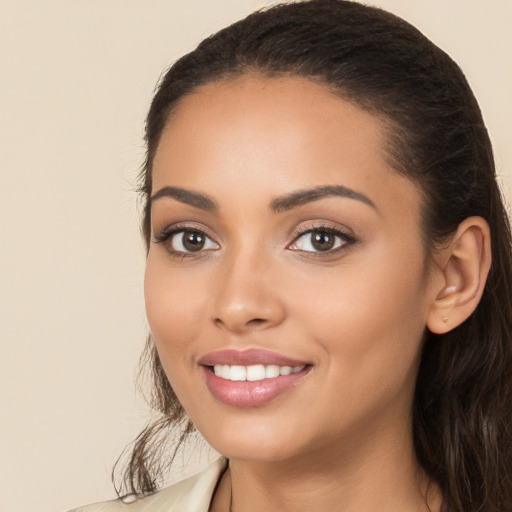 Joyful white young-adult female with long  black hair and brown eyes